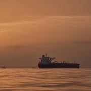 Le soleil se lève derrière des pétroliers ancrés dans le détroit d'Ormuz.