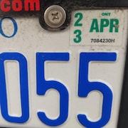 Une plaque d'immatriculation de voiture avec une vignette.