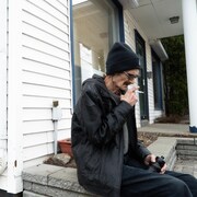 Claude, un consommateur de cocaïne, fume une cigarette après l'entrevue.