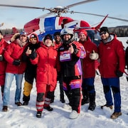 Des membres d'Airmédic posent devant un hélicoptère. 