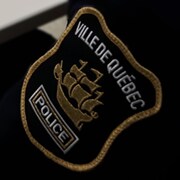 Plan rapproché d'un écusson portant les armoiries du Service de police de la Ville de Québec.