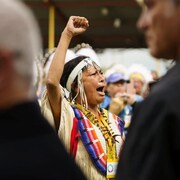 A woman sings, fist in the air.