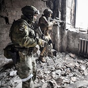 Des soldats russes prennent position dans un immeuble.