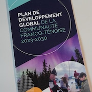 Image d'une brochure sur laquelle est écrit : « Plan de développement global de la communauté franco-ténoise 2023-2030 », le 3 mai 2024, à Yellowknife, aux T.N.-O.