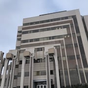 Un pavillon d'université sur fond de ciel gris.