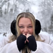 Une jeune femme est prise en photo dehors sous la neige.