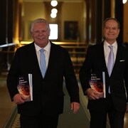 Ontario Premier Doug Ford and Finance Minister Peter Bethlenfalvy arrive to the legislature chamber with their new budget. The $232-billion plan delivers on a promise the premier made during his reelection campaign in February to spend big on tariff relief programs. 