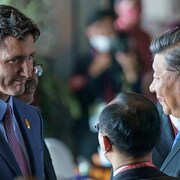 Justin Trudeau serre la main de Xi Jinping dans une foule.