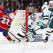 Nov 29, 2022; Montreal, Quebec, CAN; Montreal Canadiens right wing Cole Caufield (22) misses his shot on San Jose Sharks goalie Kaapo Kahkonen (36) during the second period at Bell Centre. Mandatory Credit: David Kirouac-USA TODAY Sports