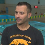 Abderrahmane Tissira en entrevue dans les gradins menant à la piscine des Cougars de l'Université de Regina. 