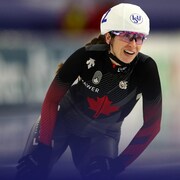 Une patineuse de vitesse performe lors d'une compétition.