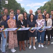 Des gens posent avec une bande des Championnats du monde de cyclisme 2026.