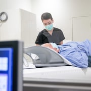 Un patient subit un examen d'imagerie médicale.