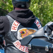 Gros plan sur la veste d'un homme à moto. On voit le logo des Hells Angels et la mention de la bande de motards et de la province de l'Île-du-Prince-Édouard.