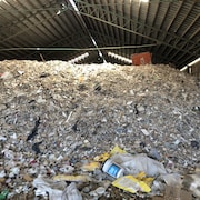Des tonnes de déchets dans un bâtiment délabré.