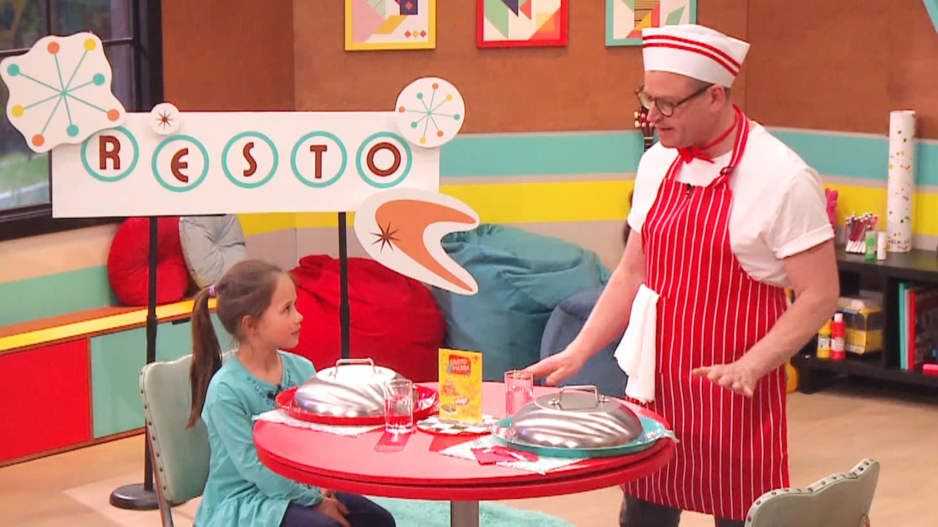 A child and Danny are in a restaurant setting. 