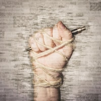 Une main tenant un stylo est attachée.