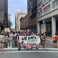 Des manifestantes brandissent une banderole où il est écrit : Nous sommes dans l'urgence climatique.