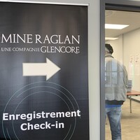 Une affiche indique « Mine Raglan, une compagnie Glencore, enregistrement, check in ».