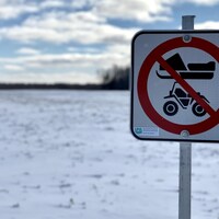 Une affiche interdisant l'entrée dans les champs des motoneiges et des véhicules tout terrain.