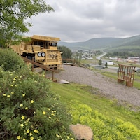 Un camion utilisé dans les mines est stationné au sommet d'une colline qui surplombe la municipalité de Murdochville.
