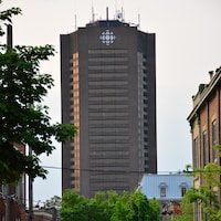 La tour de Radio-Canada émerge derrière les arbres de la rue Panet.