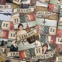 Des cartes sur une table avec des noms comme « LeBlanc », « Babineau » et « Melanson ».