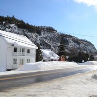 Des maisons le long d'une route traversant le village de Petit-Saguenay.