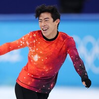 Le patineur artistique américain Nathan Chen sourit sur la glace.