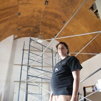 Marie-Luce Quéverdo dans une salle au plafond très élevé. 