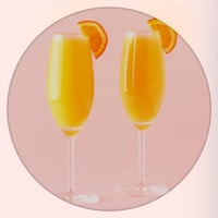 Deux verres de mimosa coiffés d'une tranche d'orange
