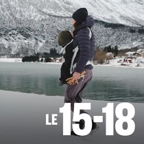 Caroline Côté et son enfant au bord d'un lac, devant des montagnes enneigées.