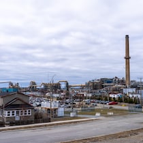 Deux cheminées s'élèvent au cœur d'un complexe industriel.