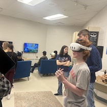 Plusieurs jeunes et un adulte dans une salle de jeux.