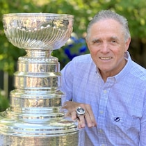 Michel Boucher avec sa bague témoignant de la victoire de l'équipe et la coupe Stanley dans sa cour, à Trois-Rivières.