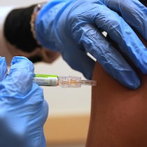 Un pharmacien administre le vaccin annuel contre la grippe à un patient, le 9 septembre 2025.