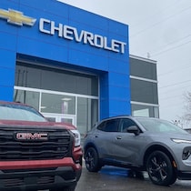 Des voitures devant un concessionnaire Chevrolet.