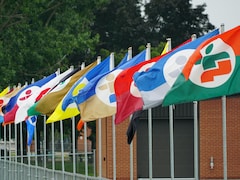 Des drapeaux des Jeux du Québec enlignés.