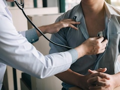 Un médecin utilise un stéthoscope pour écouter le rythme cardiaque d'un patient.