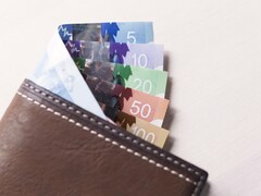 Des billets de banque canadien dans un portefeuille de cuir brun. 