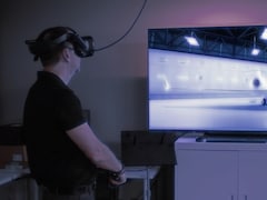 Une personne utilise un casque de réalité virtuelle pour observer la version numérisée d'un aéronef.