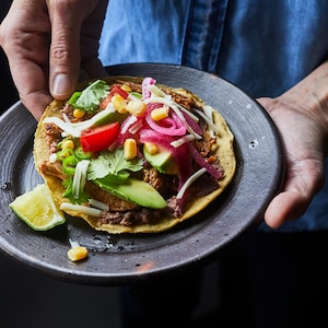 Tostadas au porc effiloché dans une assiette.