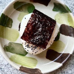 Un onigiri au thon dans une assiette.