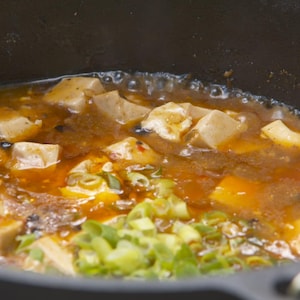 Du tofu mapo dans une casserole.