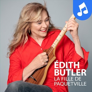 Photo d'Édith Butler jouant d'un instrument à corde similaire à une guitare.