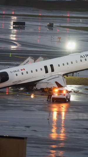 Un avion au sol est incliné, la cabine de pilotage complètement détruite.