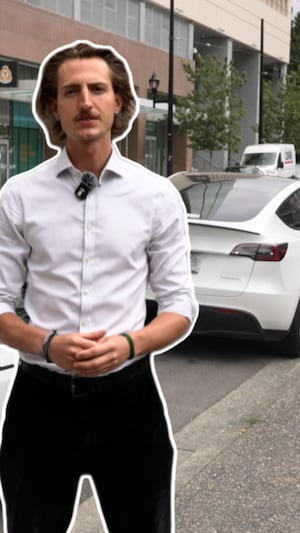 Le journalise Ivan de Jacquelin devant une tesla, à Vancouver.