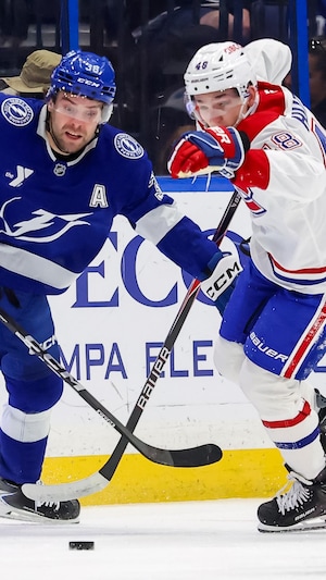 Deux joueurs adverses luttent pour la rondelle.