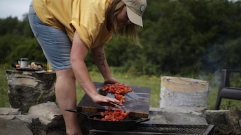 Frédérike de Folks & Forks en train de brasser sa chakchouka dans une poêle sur le feu.