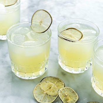 Limonade lime, coco et menthe dans des verres garnis d'une tranche de lime séchée.